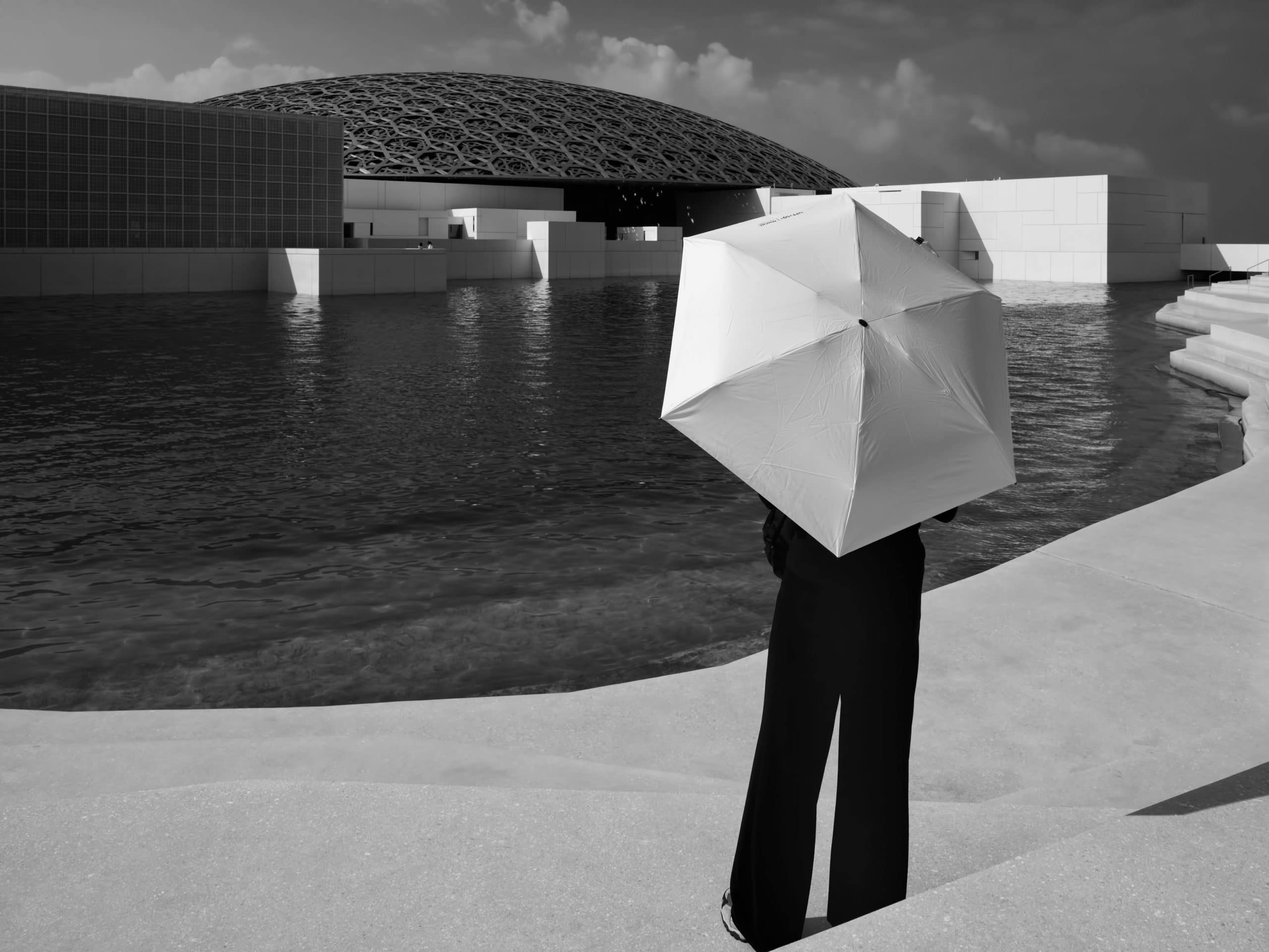 Louvre umbrella woman Abu Dhabi